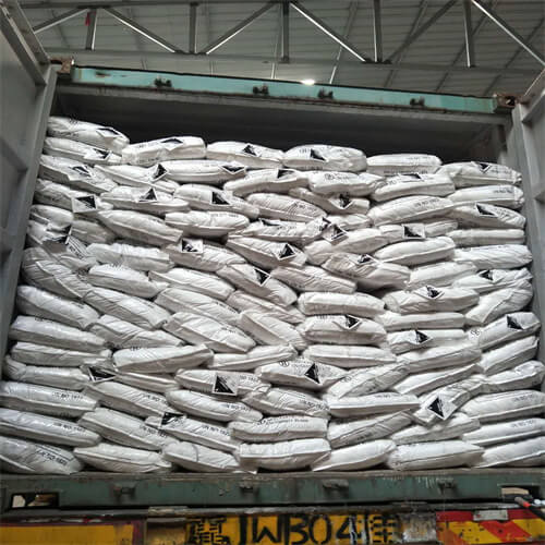 Caustic Soda Flakes loading into container.png